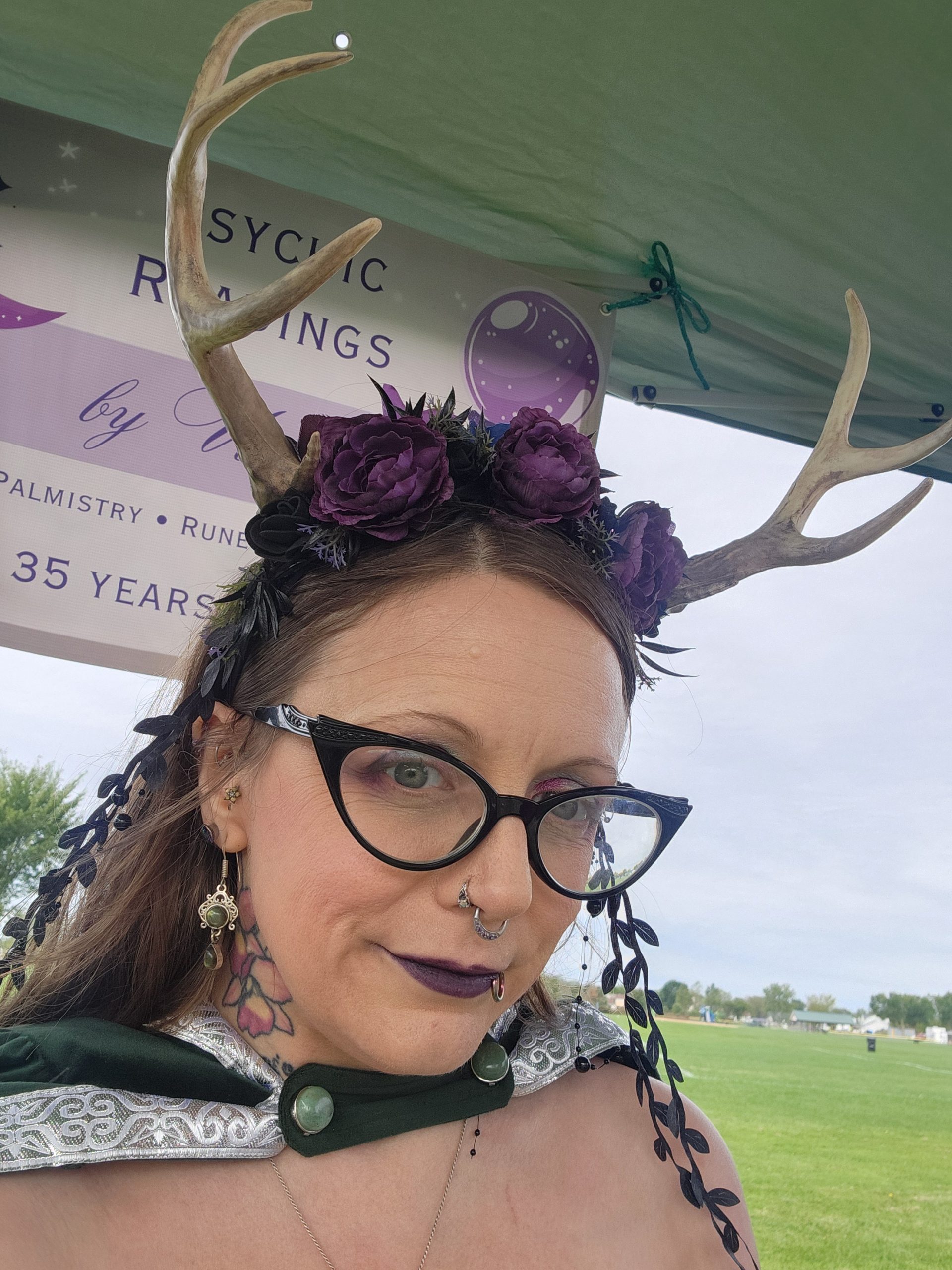 Victoria wearing an antler headpiece and smiling slightly
